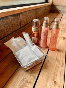 a group of bottles ofmetics sitting on a wooden table at Sarusawaike Yoshidaya in Nara