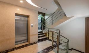 a staircase in a house with a glass door at Hiland suites in Bangalore