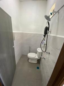 a bathroom with a toilet and a shower at Cantik-La Homestay Kuala Terengganu 3 Bilik in Bukit Payong