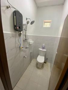 a bathroom with a toilet and a shower stall at Cantik-La Homestay 3 Bilik Kuala Terengganu in Bukit Payong