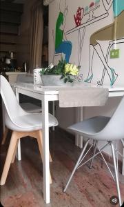 a table with two chairs and a table with flowers on it at Sweet Sweet Home in Tolve