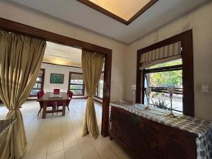 a living room with a large window and a table at Sheridan Boutique Resort Iloilo in Iloilo City