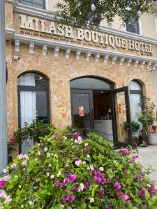 a mitzel boutique hotel with flowers in front of it at Milash Boutique Hotel in Ha Long