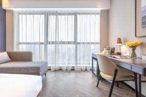 a hotel room with a desk and a window at Atour Hotel Wuhan Chuhe Han Street Hongshan Plaza in Wuhan