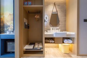 a bathroom with a white sink and a mirror at Atour Hotel Qingyuan Shunying Guangbai in Qingyuan