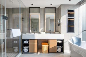 a bathroom with a sink and two mirrors at Atour Hotel Nanjing Medical Valley Xinghuo Road in Nanjing +14 photos