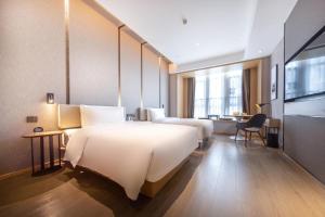 Postel nebo postele na pokoji v ubytování Atour Hotel Qingyuan Shunying Guangbai