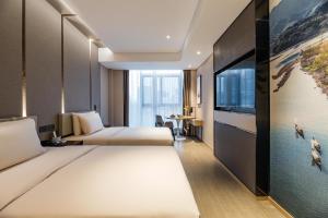寧波的住宿－宁波外滩路劲新天地亚朵酒店，酒店客房设有两张床和一台平面电视。