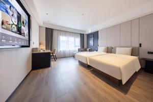 Postel nebo postele na pokoji v ubytování Atour Hotel Guangzhou Baiyun Jiahe Hebian