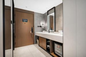 a bathroom with a sink and a mirror at Atour Hotel Chengdu Jinhua Wanda Liulichang in Chengdu