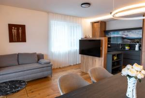 a living room with a couch and a table at Bella Vista Seeblick in Annenheim +20 photos
