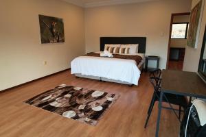 A bed or beds in a room at Imvubu Lodge - Zulweni Private Game Reserve