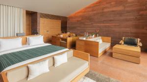a bedroom with a bed and a tub and a sink at Potato Head Suites & Studios in Seminyak