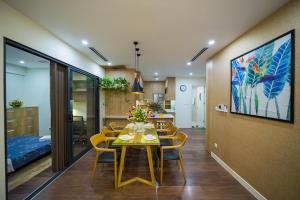 une salle à manger avec une table et des chaises ainsi qu'une chambre dans l'établissement iHome Luxury Apartment Imperia Garden, à Hanoï