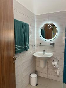 a bathroom with a sink and a mirror at A Home Away from Home. in Fumba