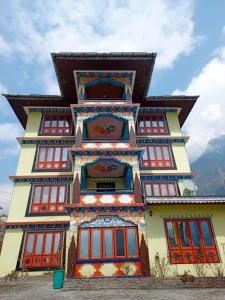 a building with red and blue windows at Rufina Lachung Heritage in Lachung