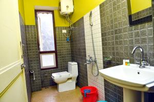 a bathroom with a toilet and a sink at Rufina Lachung Heritage in Lachung +30 photos