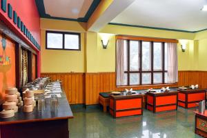 a large room with a row of tables and windows at Rufina Lachung Heritage in Lachung