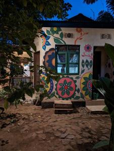 uma casa com um mural colorido ao lado em Backyard Hostel em Moshi