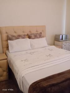 a bedroom with a large bed with a white blanket at Bullez guest house in Mahikeng