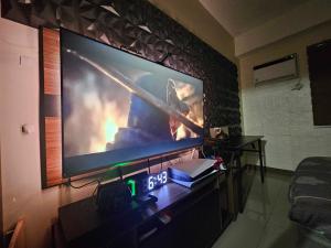 Elle comprend une grande télévision à écran plat suspendue au mur. dans l'établissement Gamingcation, à Manille