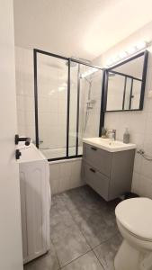 a white bathroom with a toilet and a sink at Cozy 2-Room Flat, for Vacation & Fair (Messe Düsseldorf) in Ratingen