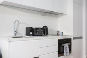a kitchen counter with a sink and a stove at Boutique Studio Apartment in Heritage Home in Sydney