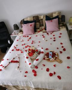 a bed with red hearts on it at Teslić Apartman NiA in Teslić