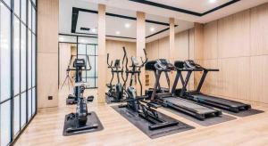 a gym with several treadmills and elliptical machines at Atour Hotel South Business Zone Ningbo in Ningbo