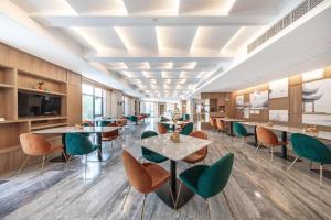 a dining room with tables and chairs at Atour Hotel Ningbo Yinzhou Wanda Mingzhouli in Ningbo