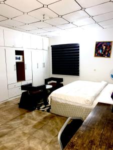 a bedroom with a bed and a table and chairs at APARTMENT 30A in Abuja