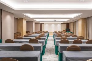 a row of tables and chairs in a room at Atour Hotel Presidential Residence Nanjing in Nanjing