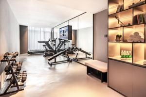 a room with a gym with tread machines and a tv at Atour Hotel Guangzhou Baiyun Jiahe Hebian in Guangzhou