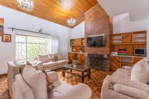 a living room with couches and a fireplace at Bonsai Village in Nairobi