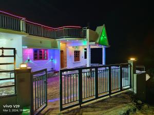 a house lit up at night with colorful lights at Munnar Pavithra Riverview Homestay in Munnar