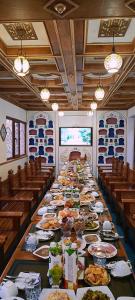 a long table with plates of food on it at Hotel Ansi Boutique W&S terrace in Bukhara