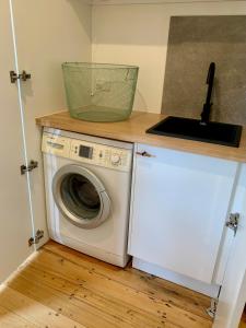 a laundry room with a washing machine and a counter at Frankston South Beachside Gem in Frankston South