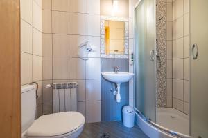 a bathroom with a toilet a sink and a shower at Pokoje gościnne Siodemka in Zakopane +65 photos