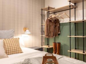 a bedroom with a bed and racks of clothes at Bilbao Intermodal by Aston Rentals in Bilbao
