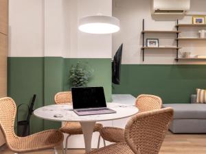 a table with a laptop on it in a room at Bilbao Intermodal by Aston Rentals in Bilbao