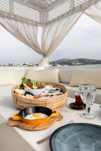 a table with a basket of food on a table at Bilkent Casa Costa Hotel in Gundogan