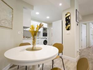 una sala da pranzo bianca con tavolo e sedie bianchi di Bilbao Costa III by Aston Rentals a Getxo