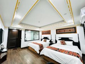 Postel nebo postele na pokoji v ubytování Trung Huyền Hotel