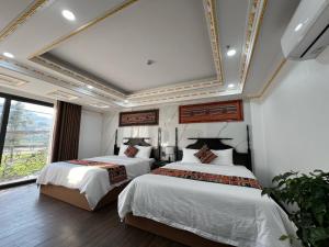 Postel nebo postele na pokoji v ubytování Trung Huyền Hotel