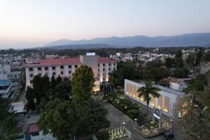 an overhead view of a city with a building at Hotel Madhuban in Dehradun