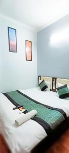 two beds sitting next to each other in a room at Prince Reseidency Near Hari Nagar in New Delhi