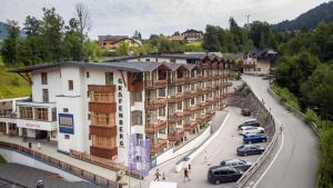 a town with cars parked in a parking lot at Grafenberg Resort by Alpeffect Hotels in Wagrain