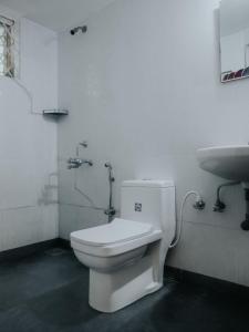 a bathroom with a white toilet and a sink at C9 Anjuna in Anjuna