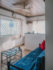 a room with a blue bed and a table at C9 Anjuna in Anjuna