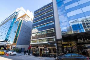 a group of tall buildings on a city street at MY Hotel in Izmir